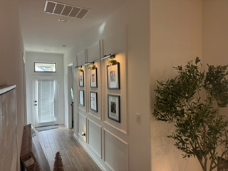 Finished hallway with gallery wall and wainscoting